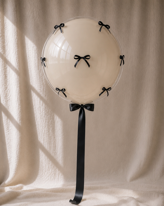 Black Tie bobo — cream balloon with black satin bows, POP Studio Auckland