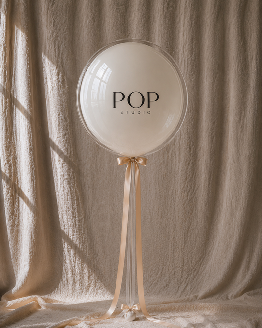 Custom Decal Bobo — cream balloon with POP Studio logo, corporate branding example