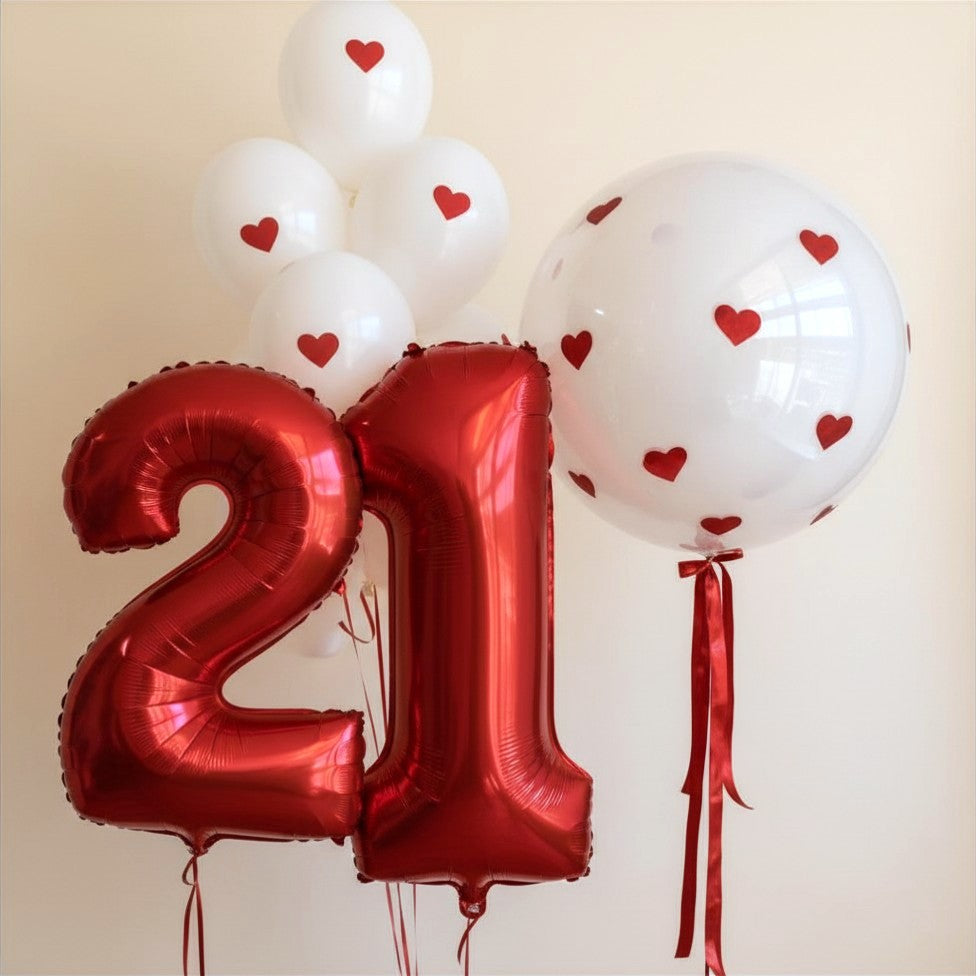Red chrome 21 number balloons with heart-decal bobo and white latex balloons, styled by Pop Studio Auckland