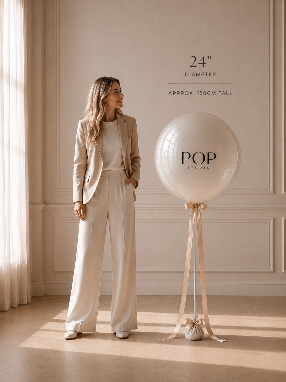 Size and scale — a 24 inch (60cm) bobo balloon stands about 150cm tall next to a person, POP Studio